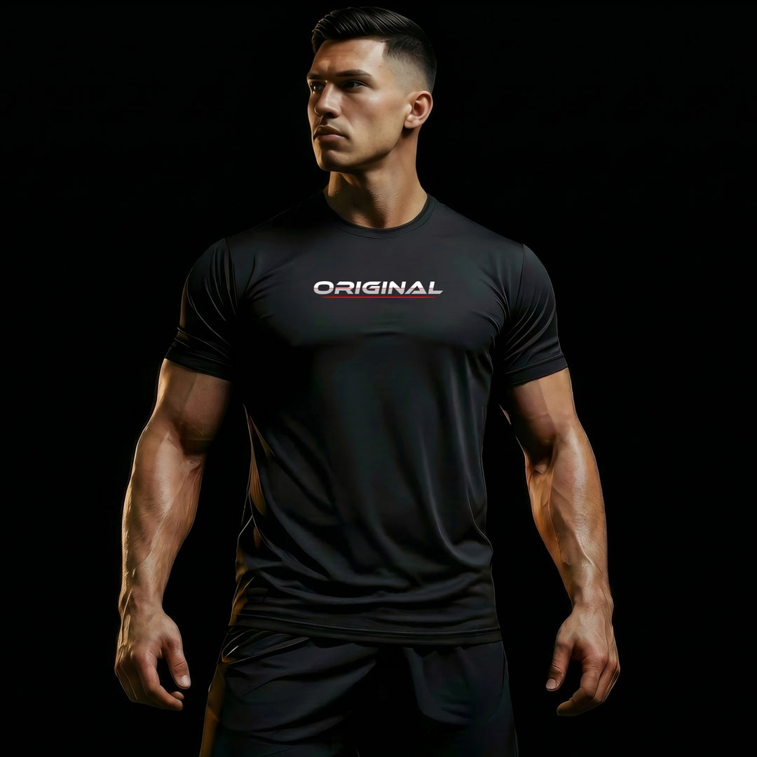 Male model wearing LIFESTYLE CORE tee with ORIGINAL front design, black athletic styling, white and grey typography, and red accent underline on a dark premium background.