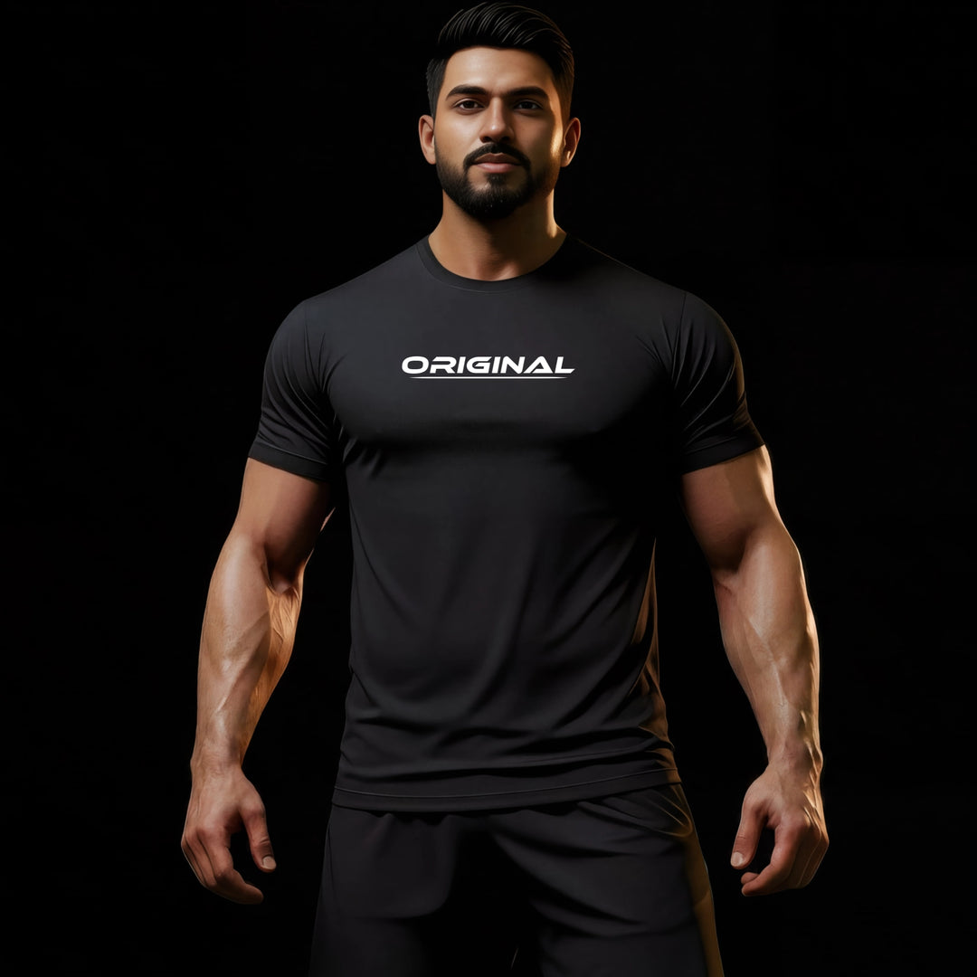 JUST-ORIGINALS LIFESTYLE ONE unisex tee model wearing the ORIGINAL I design in a premium black lifestyle look, shown front-facing against a dark minimalist background.