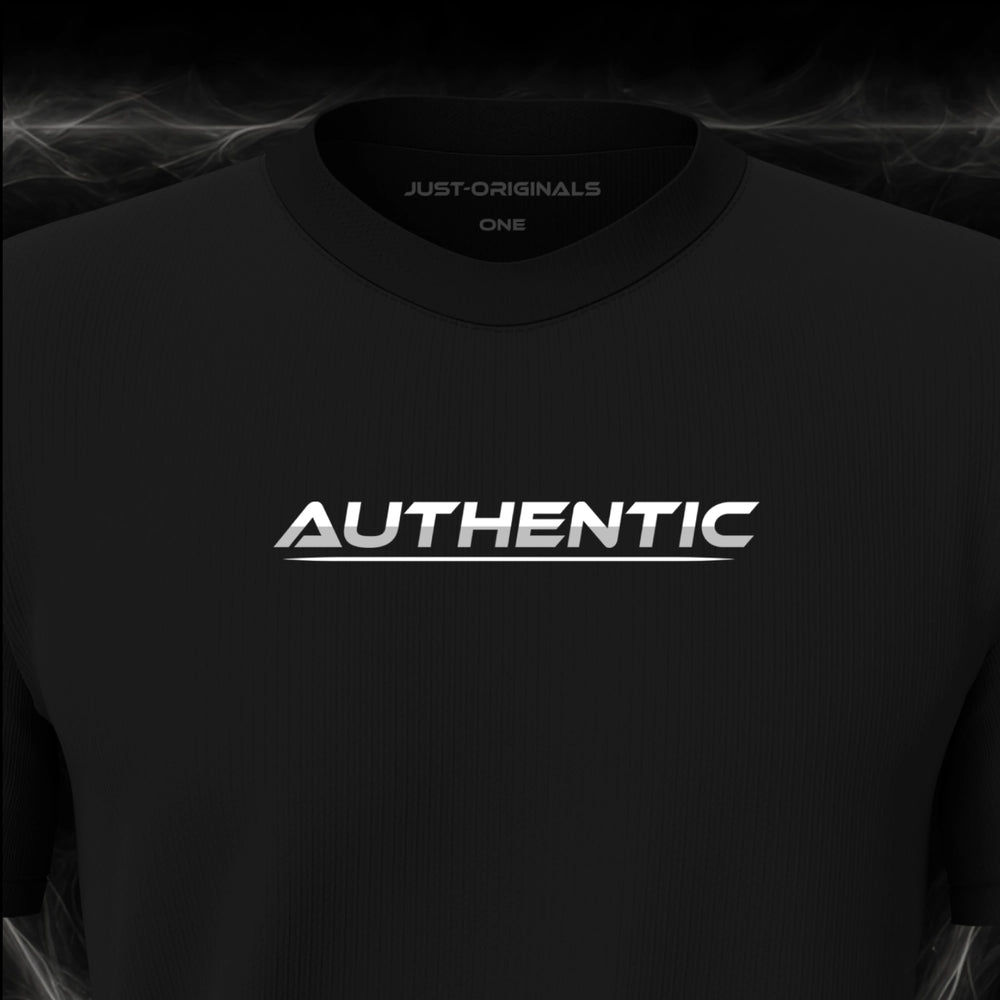 Close-up of the JUST-ORIGINALS™ LIFESTYLE ONE Unisex AUTHENTIC II design on a BlackPulse™ premium black t-shirt, featuring white AUTHENTIC typography with silver-gray accent, a white underline, and premium neck label.