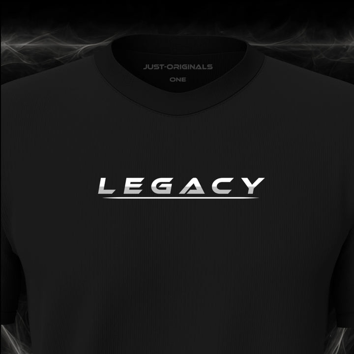 JUST-ORIGINALS™ LIFESTYLE ONE Unisex Tee — LEGACY II design close-up on BlackPulse™ premium fabric featuring white typography with subtle silver-gray accents and a white underline.