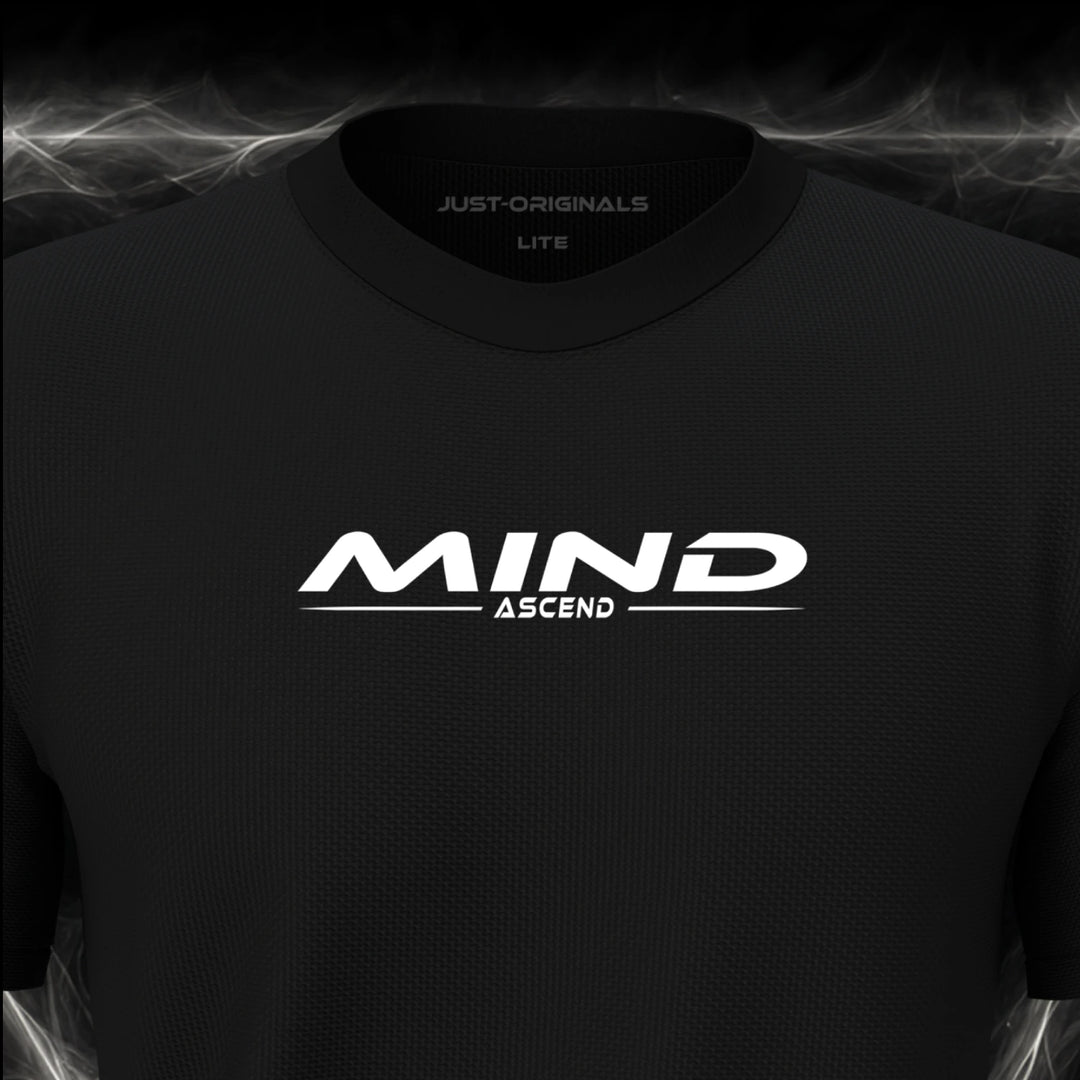 Close-up of the JUST-ORIGINALS™ MAXPULSE™ LITE Men MIND ASCEND design on a BlackPulse™ performance t-shirt, featuring white MIND typography, white ASCEND text, a white underline, and premium neck label.