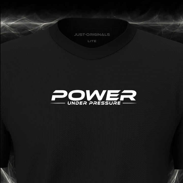 Close-up of the JUST-ORIGINALS™ MAXPULSE™ LITE Men POWER UNDER PRESSURE design on a BlackPulse™ performance t-shirt, featuring white POWER typography, white UNDER PRESSURE text, a white underline, and premium neck label.