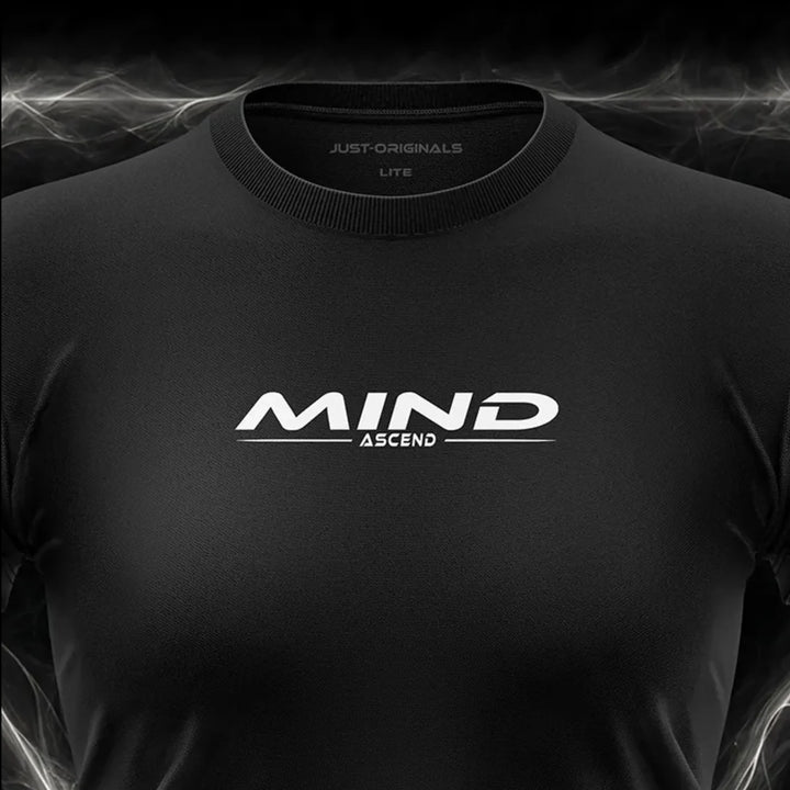 Close-up of the JUST-ORIGINALS™ MAXPULSE™ LITE Women MIND ASCEND design on a BlackPulse™ performance t-shirt, featuring white and silver MIND typography, white ASCEND text, white accent line, silver premium neck label, and premium athletic fabric.