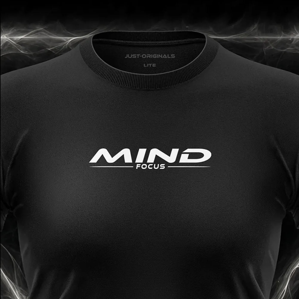 Close-up of the JUST-ORIGINALS™ MAXPULSE™ LITE Women MIND FOCUS design on a BlackPulse™ performance t-shirt, featuring white and silver MIND typography, white FOCUS text, white accent line, silver premium neck label, and premium athletic fabric.