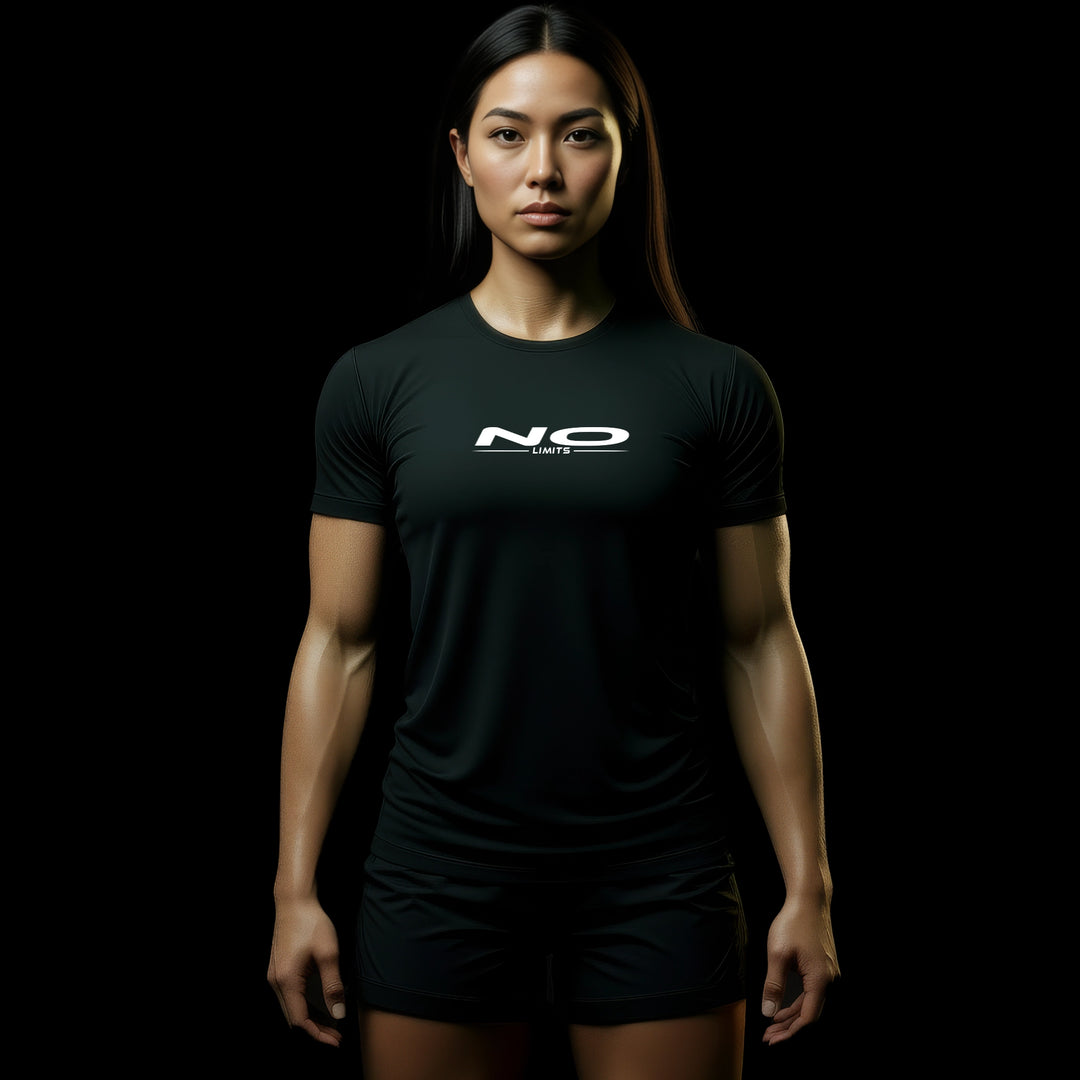 MAXPULSE™ LITE Women | NO LIMITS | BlackPulse™ performance tee | Front model view wearing lightweight athletic fit with minimal white chest print | Female fitness model front-facing with defined physique in dark studio lighting | Featured in MAXPULSE™ LITE Women Tee