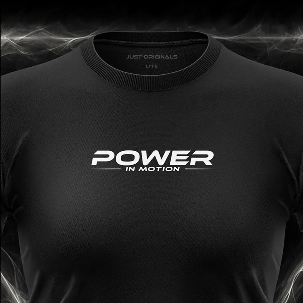Close-up of the JUST-ORIGINALS™ MAXPULSE™ LITE Women POWER IN MOTION design on a BlackPulse™ performance t-shirt, featuring white and silver POWER typography, white IN MOTION text, white accent line, silver premium neck label, and premium athletic fabric.