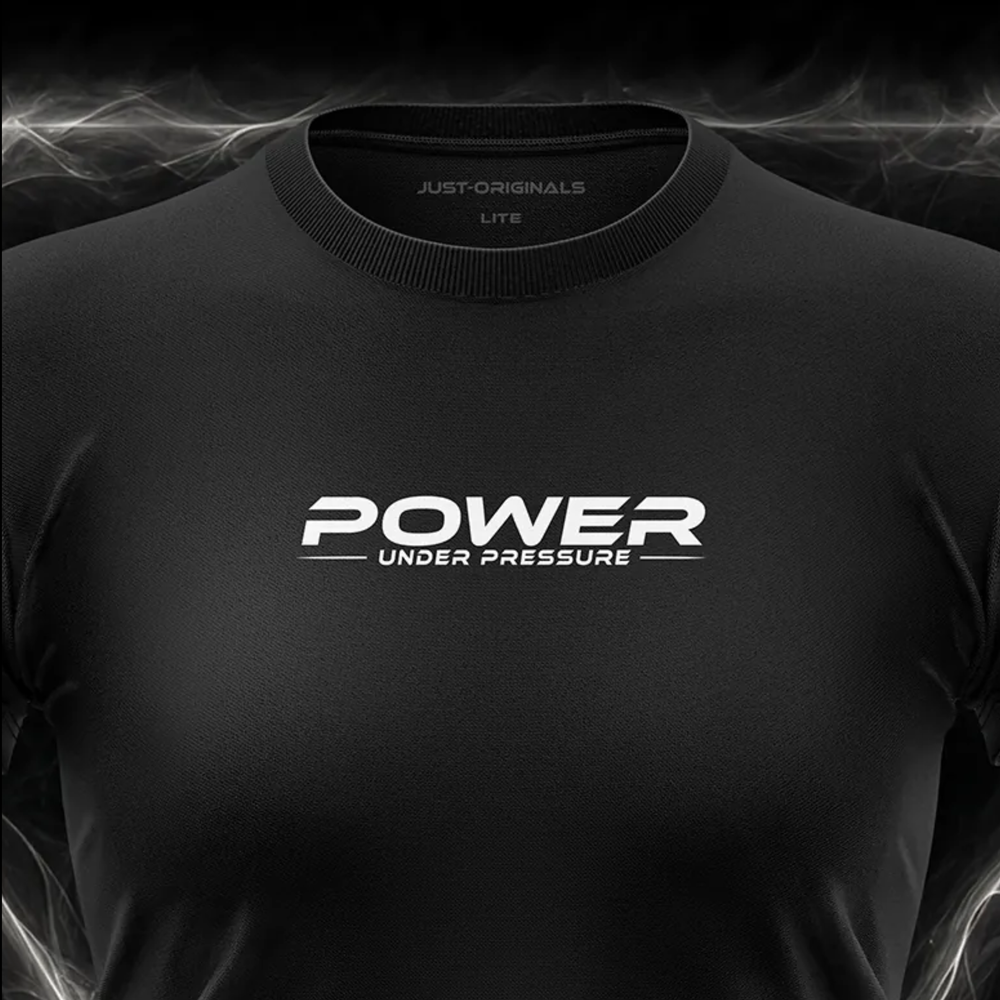 Close-up of the JUST-ORIGINALS™ MAXPULSE™ LITE Women POWER UNDER PRESSURE design on a BlackPulse™ performance t-shirt, featuring white and silver POWER typography, white UNDER PRESSURE text, white accent line, silver premium neck label, and premium athletic fabric.