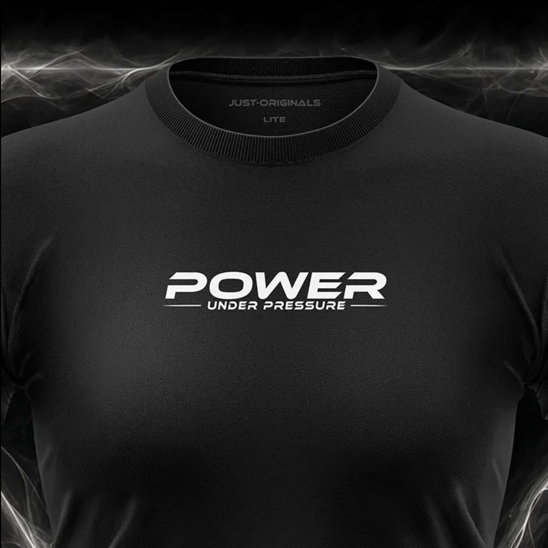 Close-up of the JUST-ORIGINALS™ MAXPULSE™ LITE Women POWER UNDER PRESSURE design on a BlackPulse™ performance t-shirt, featuring white and silver POWER typography, white UNDER PRESSURE text, white accent line, silver premium neck label, and premium athletic fabric.