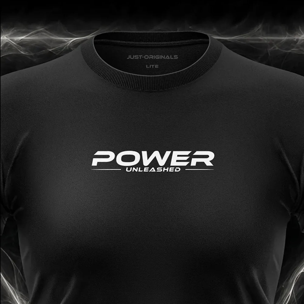 Close-up of the JUST-ORIGINALS™ MAXPULSE™ LITE Women POWER UNLEASHED design on a BlackPulse™ performance t-shirt, featuring white and silver POWER typography, white UNLEASHED text, white accent line, silver premium neck label, and premium athletic fabric.