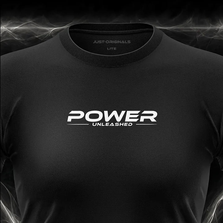 Close-up of the JUST-ORIGINALS™ MAXPULSE™ LITE Women POWER UNLEASHED design on a BlackPulse™ performance t-shirt, featuring white and silver POWER typography, white UNLEASHED text, white accent line, silver premium neck label, and premium athletic fabric.