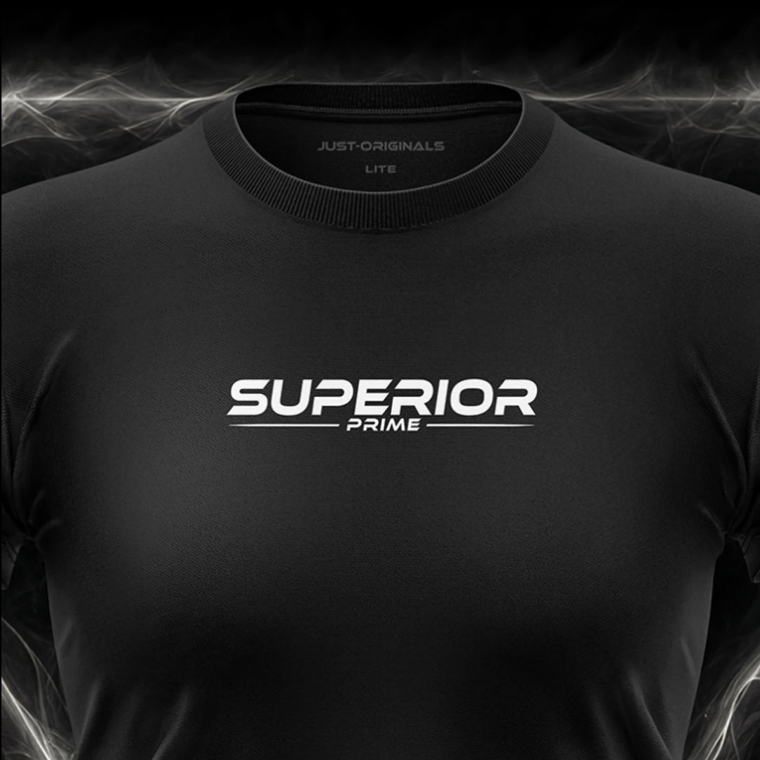 Close-up of the JUST-ORIGINALS™ MAXPULSE™ LITE Women SUPERIOR PRIME design on a BlackPulse™ performance t-shirt, featuring white and silver SUPERIOR typography, white PRIME text, white accent line, silver premium neck label, and premium athletic fabric.