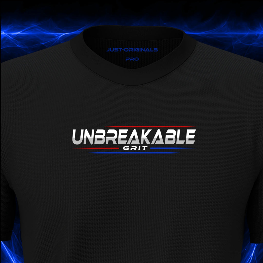 Close-up of the JUST-ORIGINALS™ MAXPULSE PRO Men UNBREAKABLE GRIT design on a BlackPulse™ performance t-shirt, featuring white UNBREAKABLE typography, white GRIT text, red and blue performance accent lines, and premium neck label.