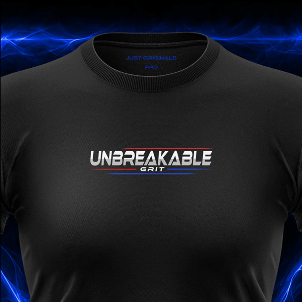 Close-up of the JUST-ORIGINALS™ MAXPULSE™ PRO Women UNBREAKABLE GRIT design on a BlackPulse™ performance t-shirt, featuring white and silver UNBREAKABLE typography, white GRIT text, red and blue accent lines, blue premium neck label, and premium athletic fabric.