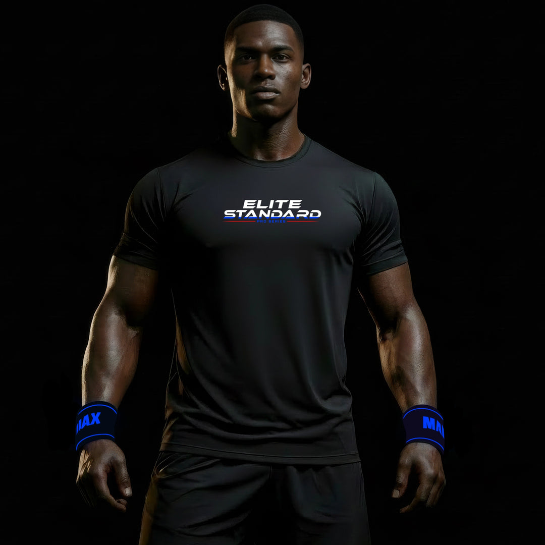 MAXPULSE™ PRO | ELITE STANDARD | Men Performance Tee | BlackPulse™ premium black athletic shirt with ELITE STANDARD chest print and blue accent underline | Male fitness model front-facing with powerful stance and defined build in minimal dark studio setting | Featured in MAXPULSE™ PRO Men Tee