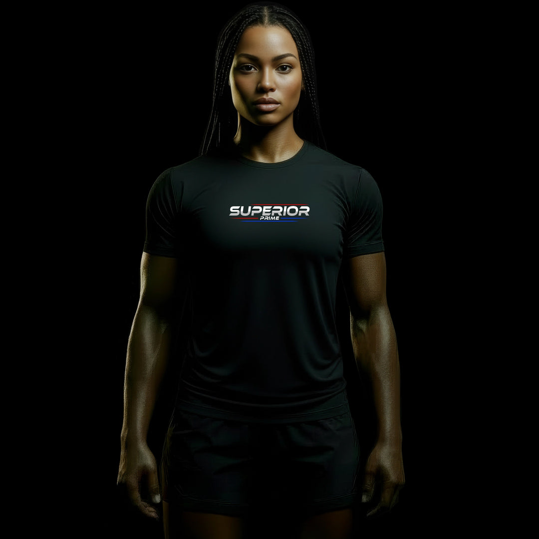 MAXPULSE™ PRO | SUPERIOR PRIME | Women Performance Tee | BlackPulse™ premium black athletic shirt with SUPERIOR PRIME chest print and blue/red accent lines | Female fitness model front-facing with strong posture and defined physique in dark studio lighting | Featured in MAXPULSE™ PRO Women Tee